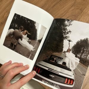 Open photo album showcasing a couple's wedding photos with a vintage feel.